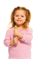stock-photo-91220581-smiling-little-girl-holding-yellow-toothbrush.jpg