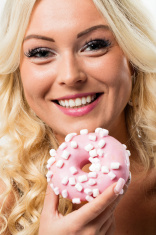 stock-photo-92657509-woman-happy-to-eat-a-pink-donut.jpg